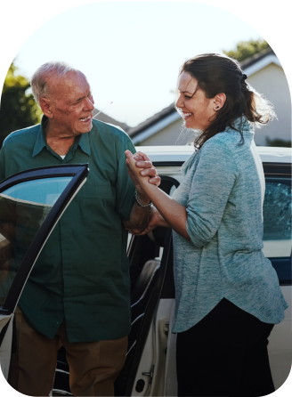 car beside senior woman and caregiver