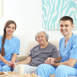 two care giver holding the hands of the senior both left and right