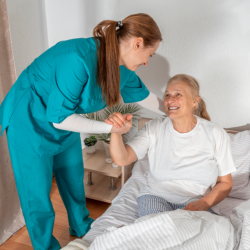 caregiver holding the hand of the senior