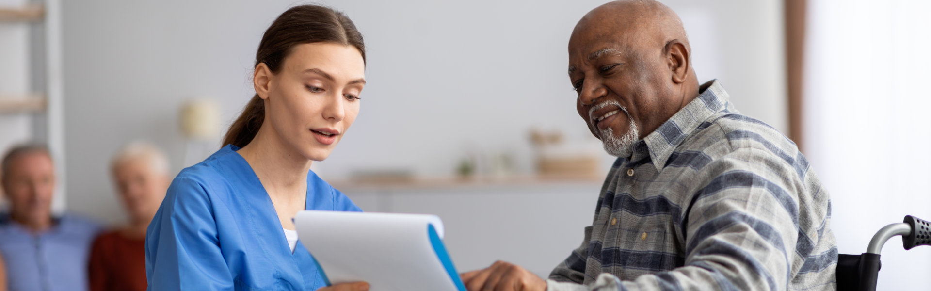 caregiver showing notes to senior