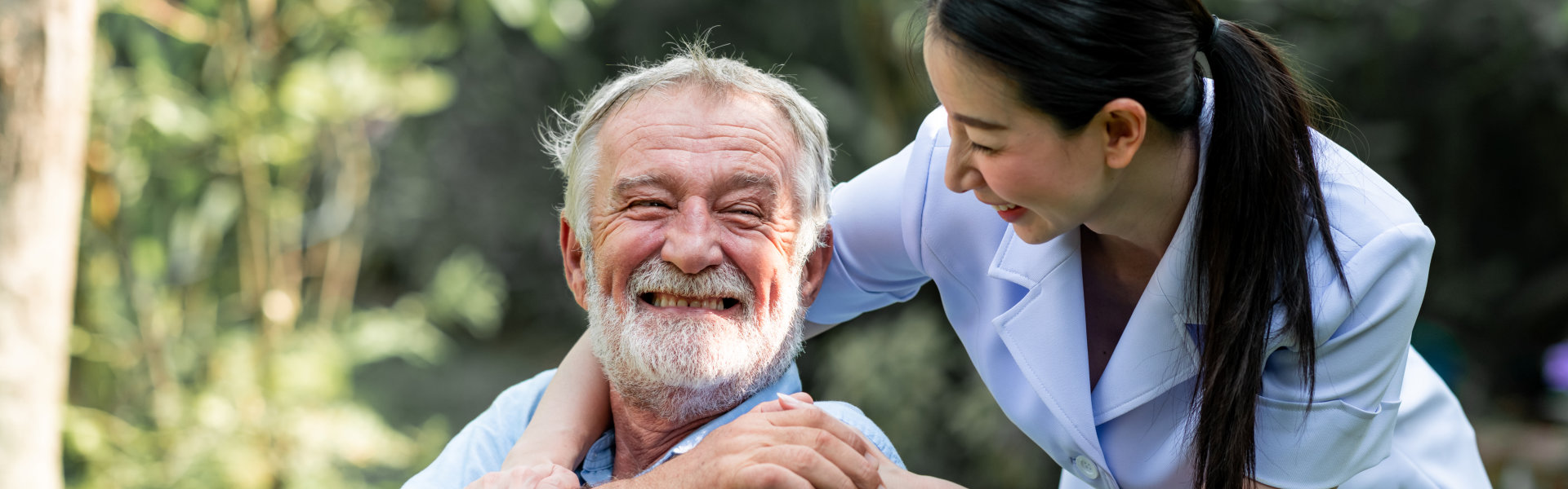 caregiver looking at the senior while smiling